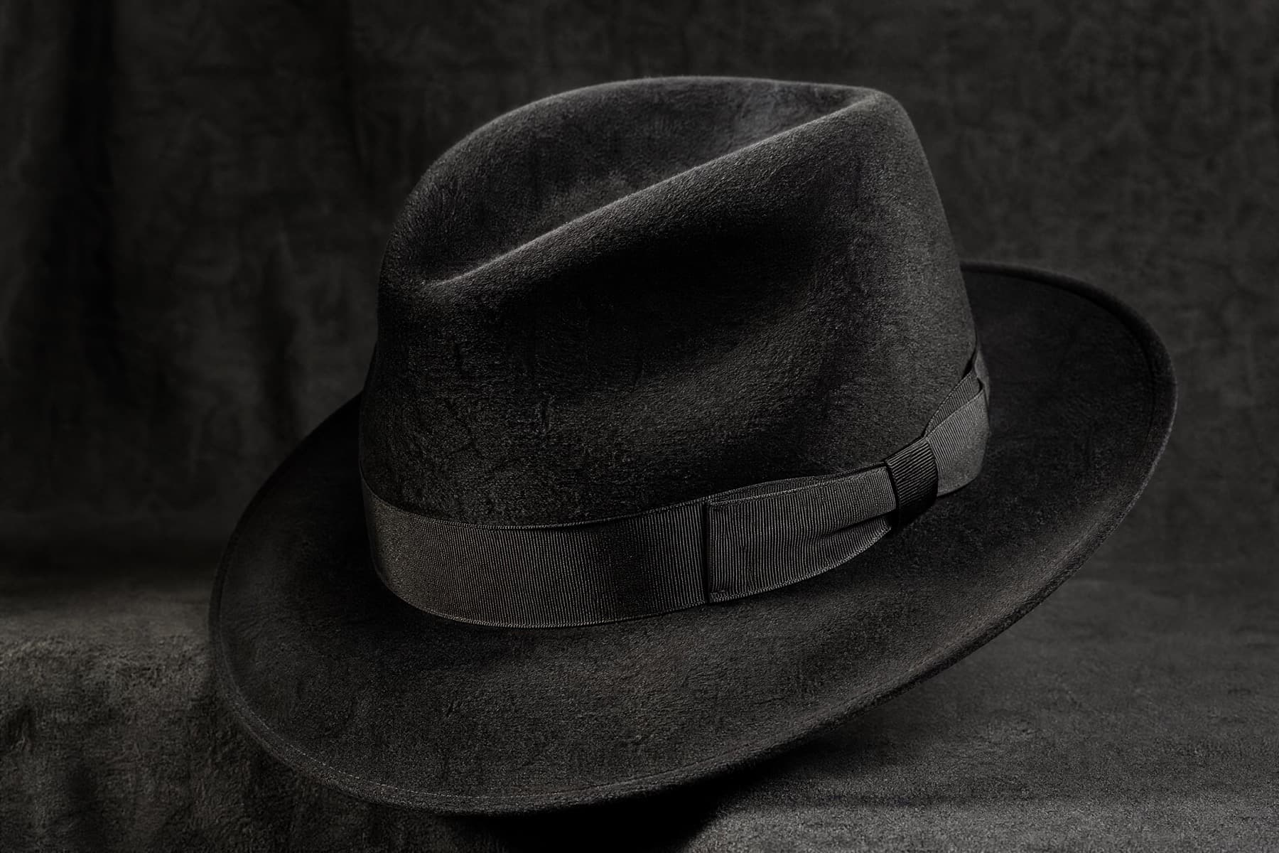 Fedora Long Nap: charcoal felt hat photographed whole under a single hard side light