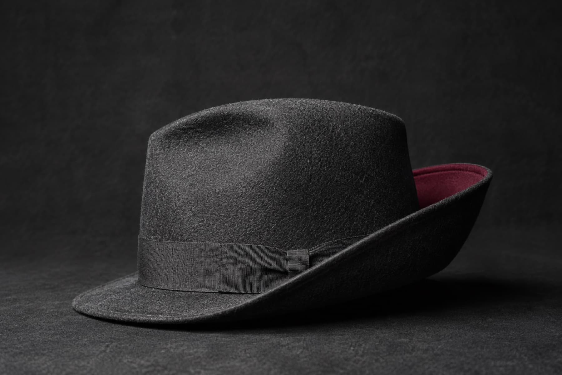 Trilby Snap Brim: charcoal felt hat photographed whole under a single hard side light