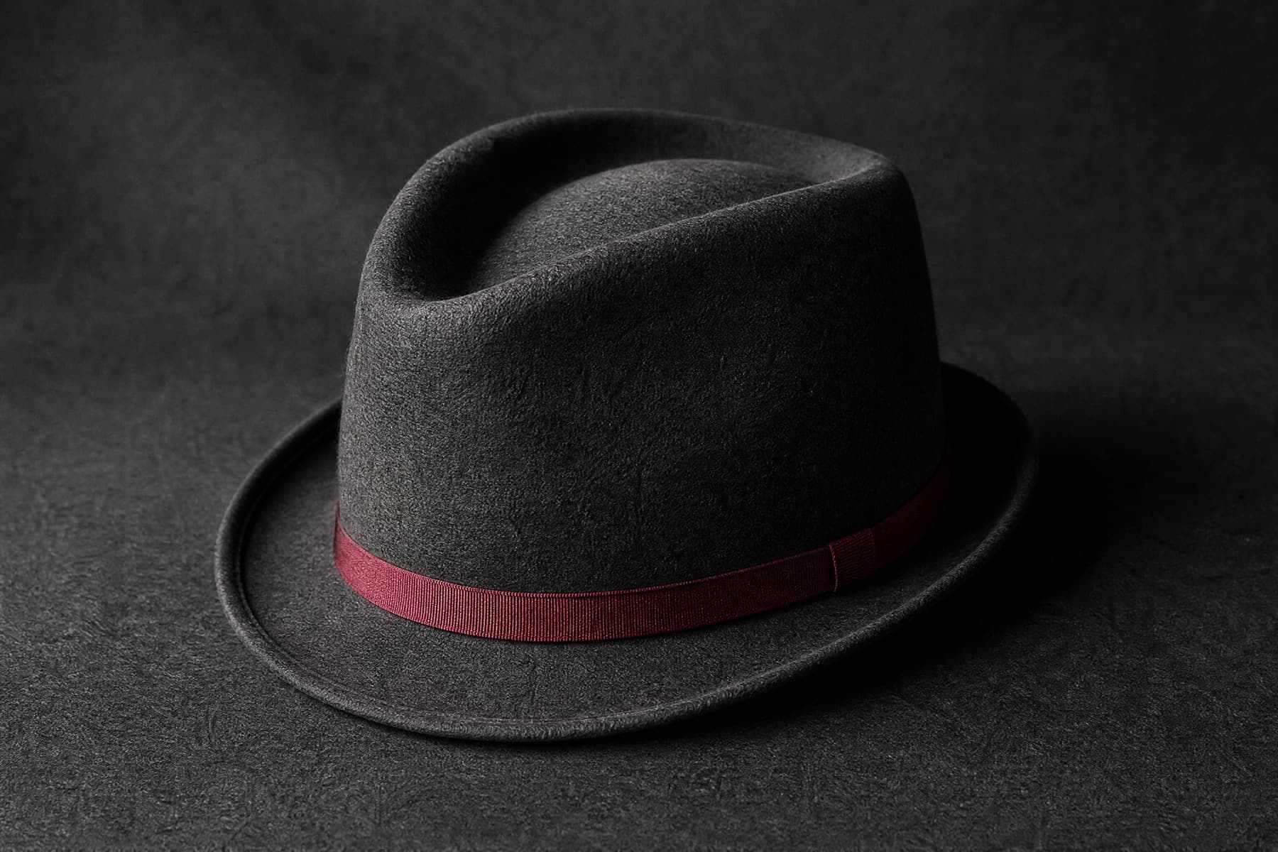 Trilby Fine: charcoal felt hat photographed whole under a single hard side light