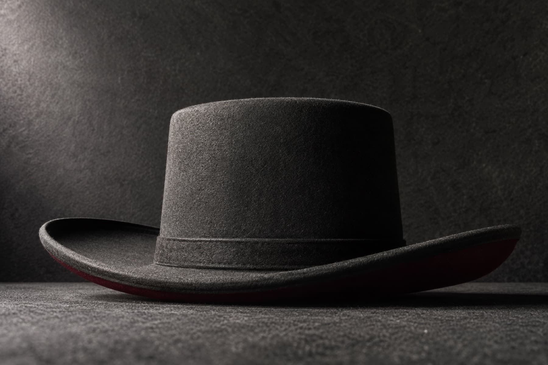 Wide 10cm Wool: charcoal felt hat photographed whole under a single hard side light