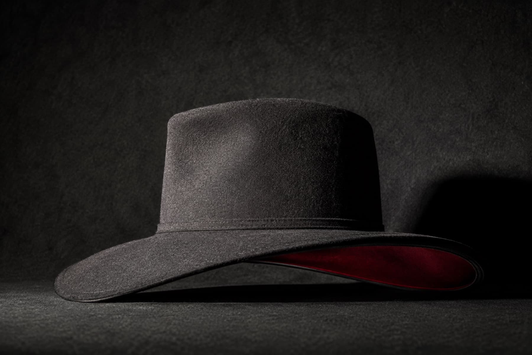 Wide Downturn: charcoal felt hat photographed whole under a single hard side light