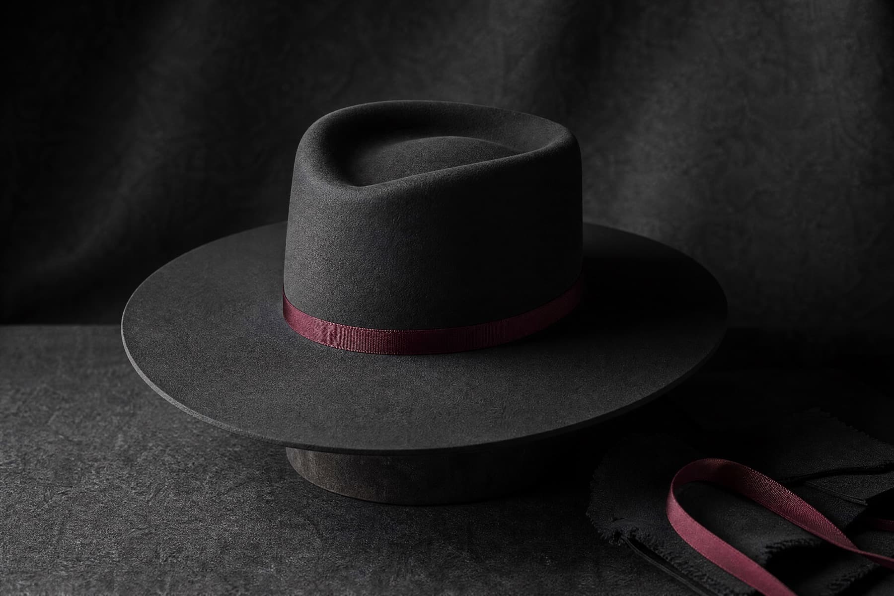 Wide Fine Rabbit: charcoal felt hat photographed whole under a single hard side light
