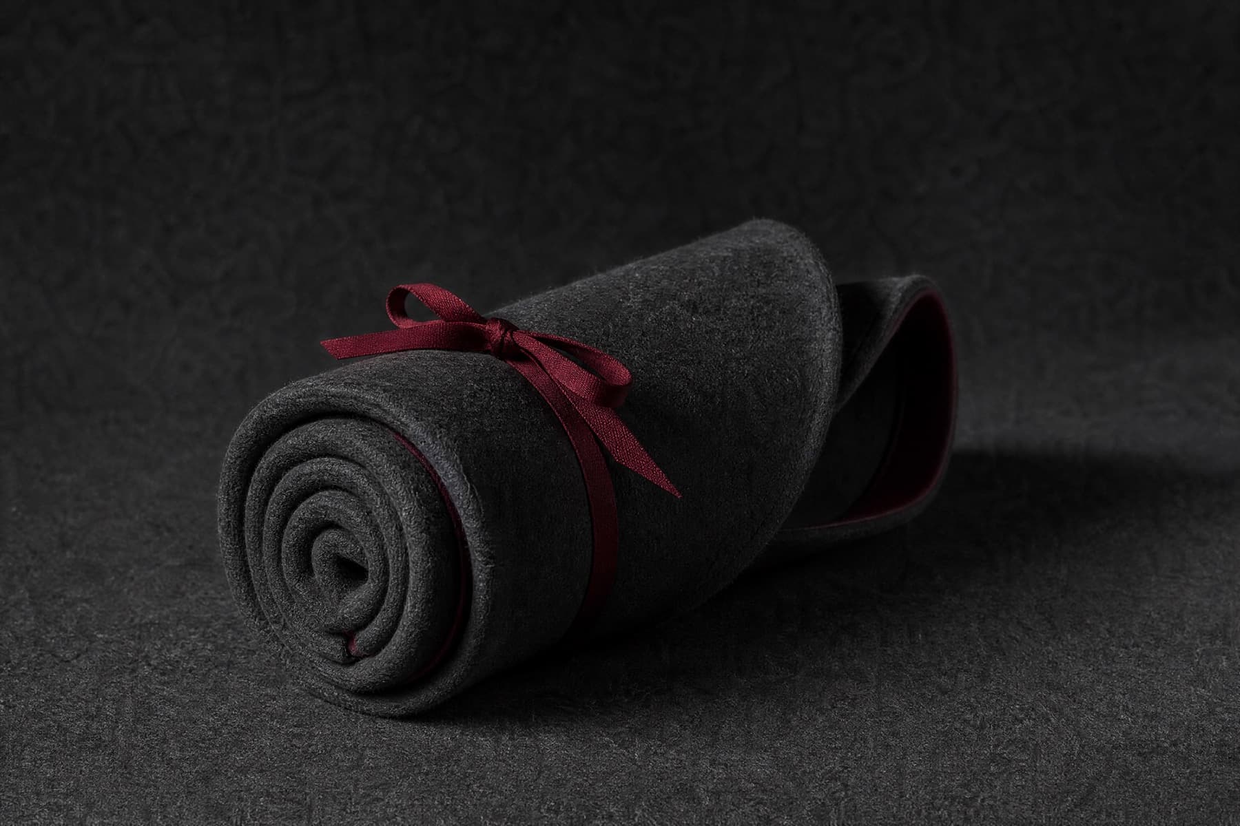 Packable Fine: charcoal felt hat photographed whole under a single hard side light